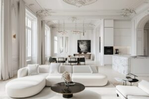 Salon lumineux d’un appartement haussmannien avec parquet en bois, moulures au plafond et cheminée en marbre.